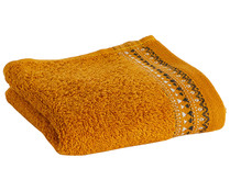 Toalla de tocador 100% algodón color amarillo ocre con cenefa Keops, 500g/m² ACTUEL.